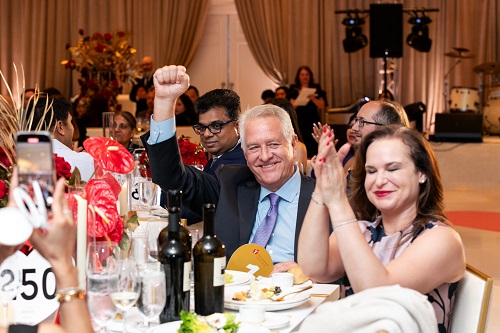 2025 Chair, Bill Brennan's, table of attendees clapping